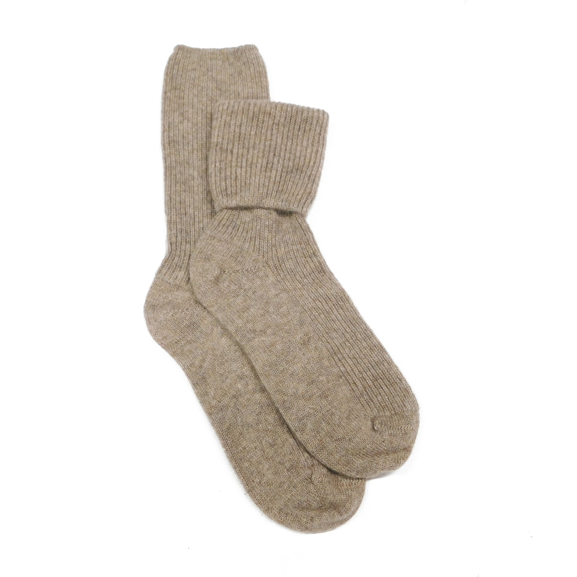 Pair of beige cashmere bed socks on a white background
