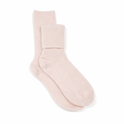 Pair of light pink cashmere bed socks on a white background